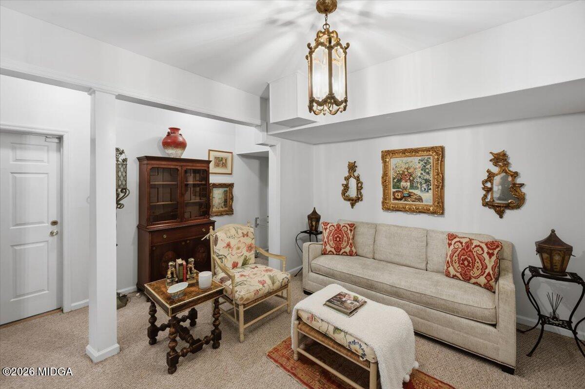 102 Merion Park Macon, GA 31210 - Photo 31 of 54 a living room with furniture a rug and a chandelier
