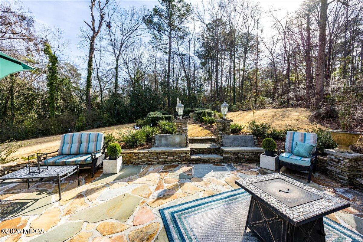 102 Merion Park Macon, GA 31210 - Photo 44 of 54 a view of a patio with couches table and chairs with wooden floor and fence