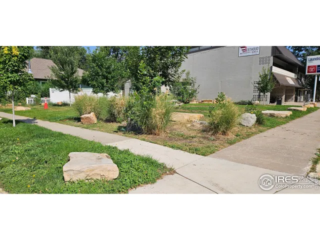a backyard of a house with a garden and outdoor seating