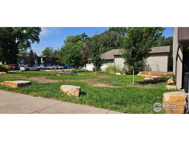 a view of a house with a yard and a garden