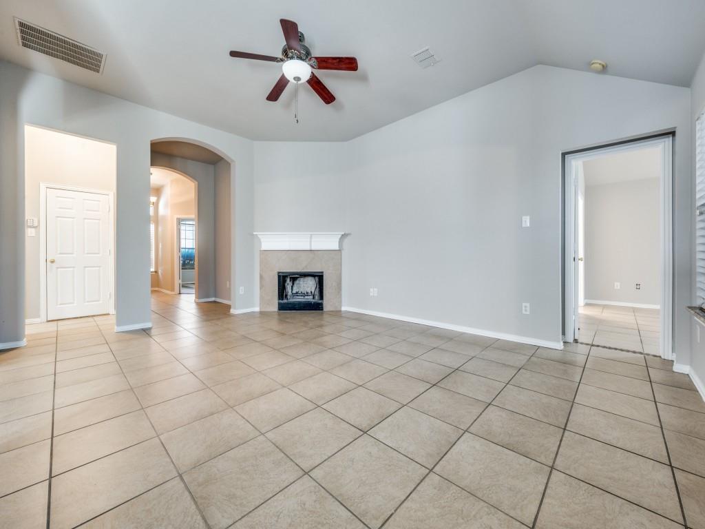 4445 Stones River Road Grand Prairie, TX 75052 - Photo 3 of 13 a view of an empty room with a fireplace
