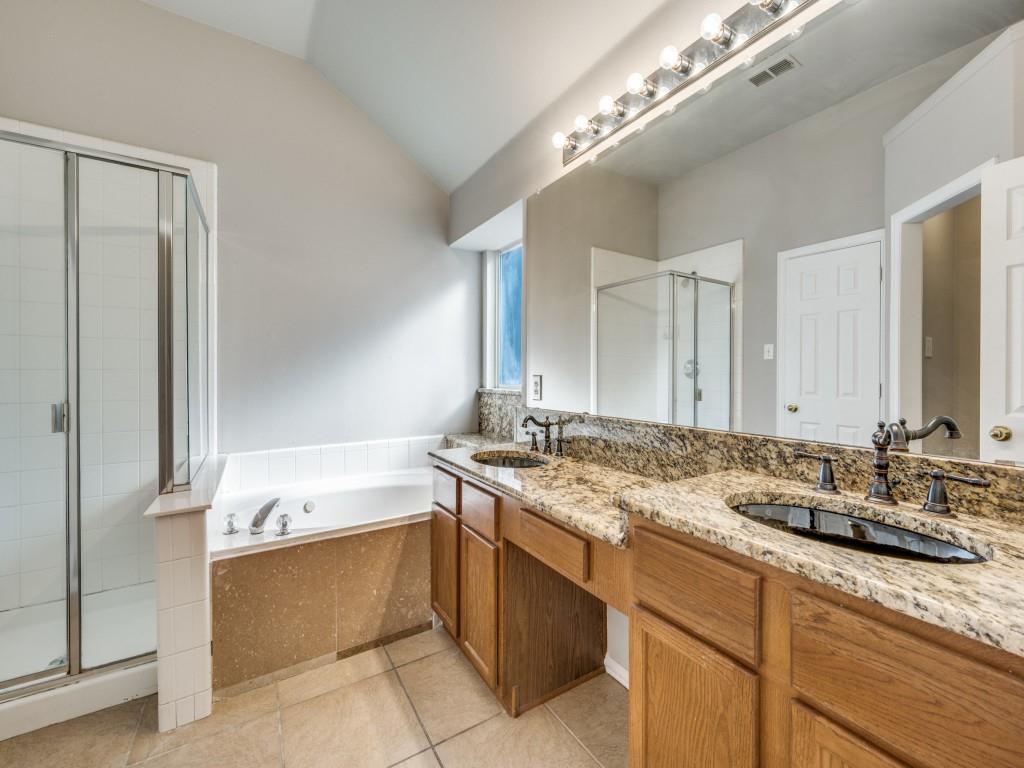 4445 Stones River Road Grand Prairie, TX 75052 - Photo 5 of 13 a bathroom with a granite countertop sink a large mirror and a bathtub