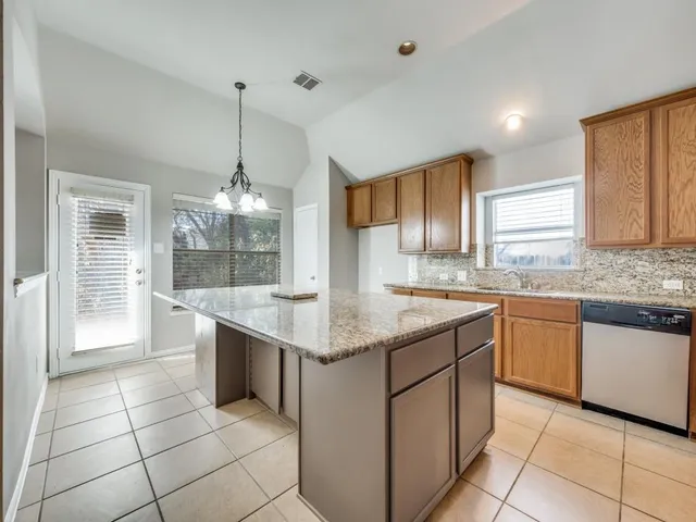 a kitchen with stainless steel appliances granite countertop a sink and cabinets