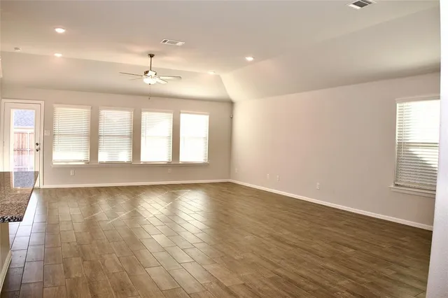 a kitchen with kitchen island granite countertop a stove and a sink