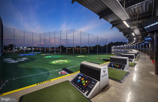 a living room with lots of furniture and a large window