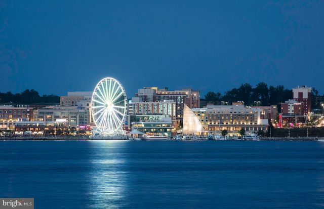 a view of swimming pool with outdoor seating and city view