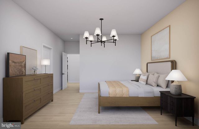 a bedroom with a large bed and a chandelier