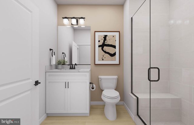 a bathroom with a double vanity sink mirror and toilet