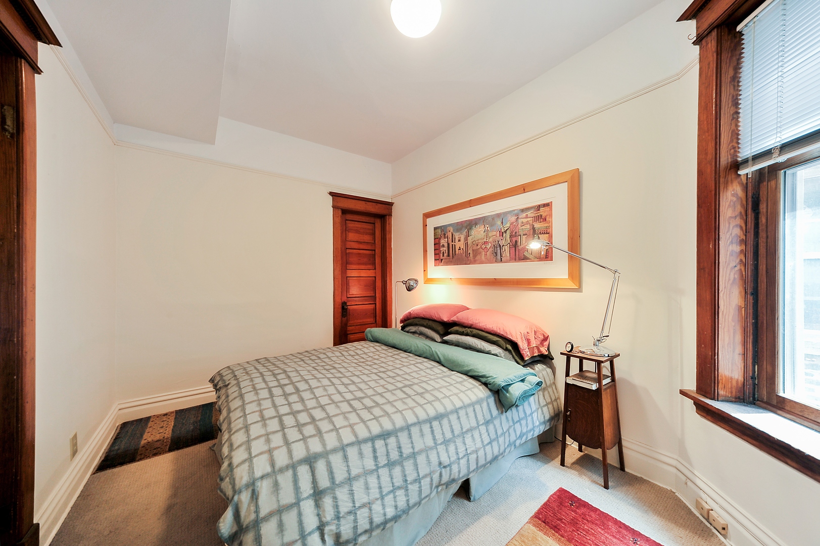 3729 North Wayne Avenue, Unit 2 Chicago, IL 60613 - Photo 8 of 17 a bedroom with a bed and a painting on the wall