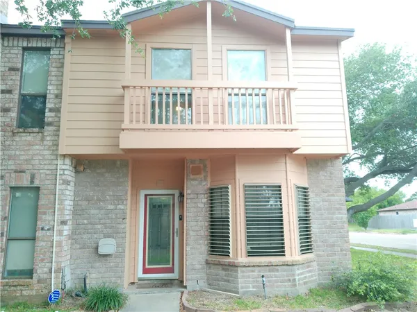 a front view of a house with plants
