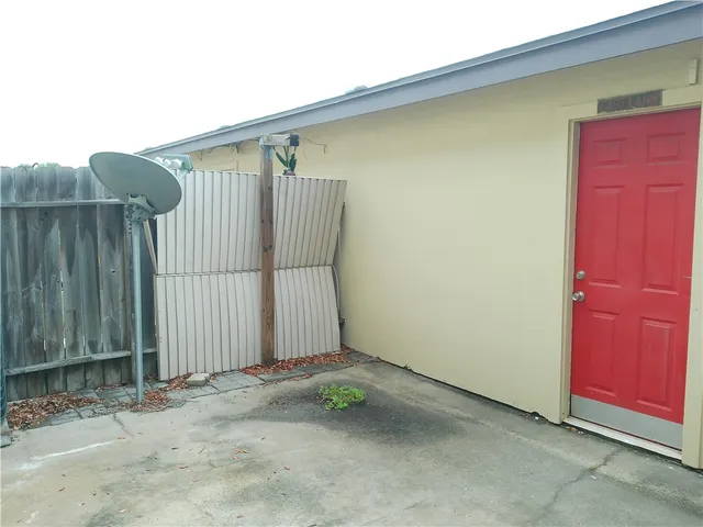 a view of a house with wooden fence