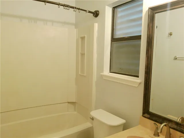 a bathroom with a shower and a toilet