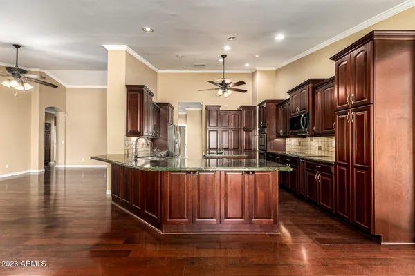 a view of a brick house with a wooden fence