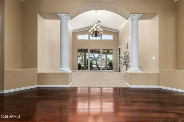 a view of a kitchen with wooden floor and a ceiling fan