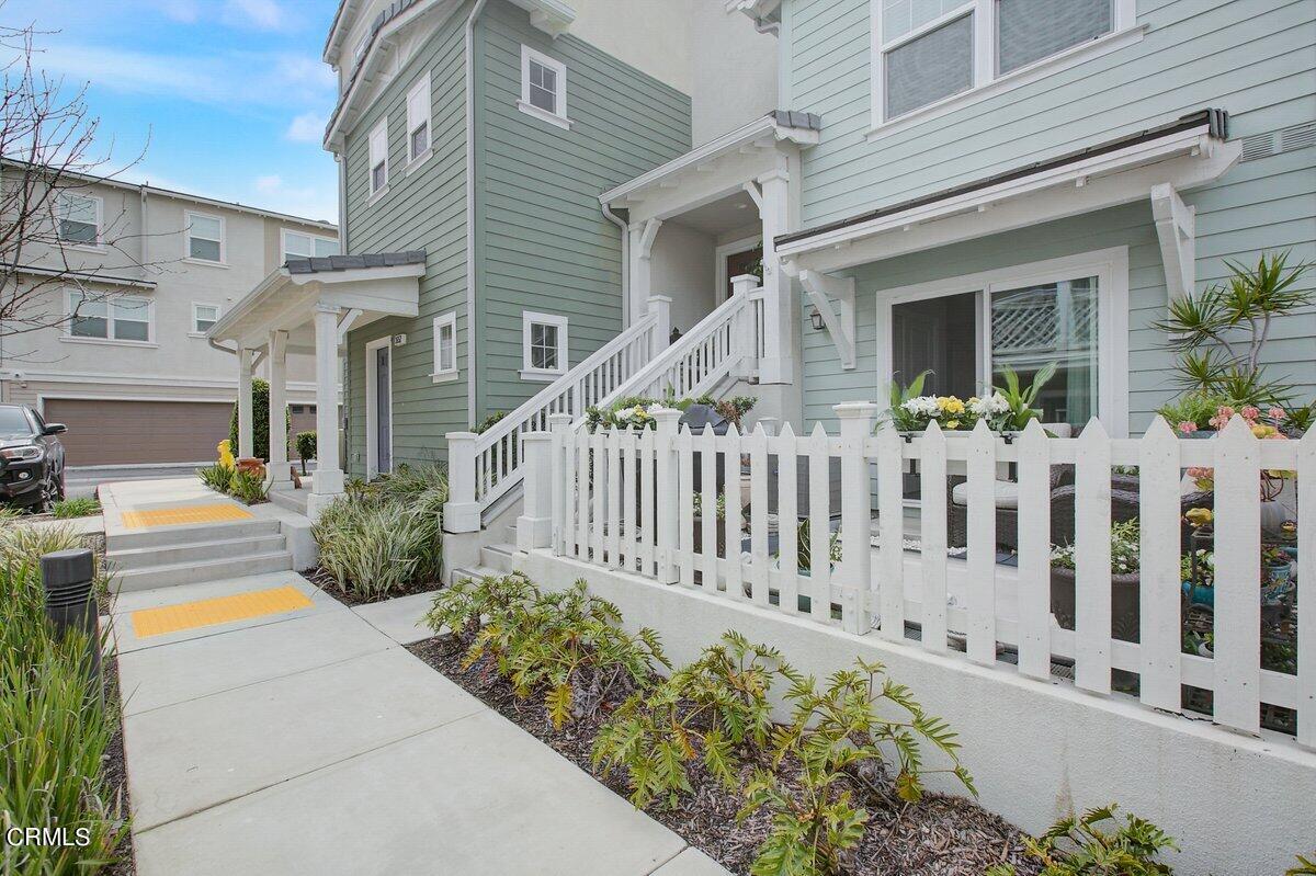 a view of a house with wooden fence