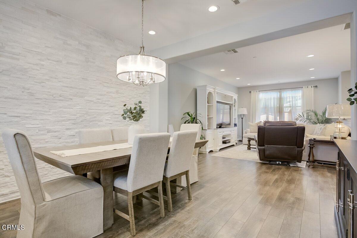 3654 Islander Walk Oxnard, CA 93035 - Photo 16 of 61 a living room with furniture a chandelier and a dining room