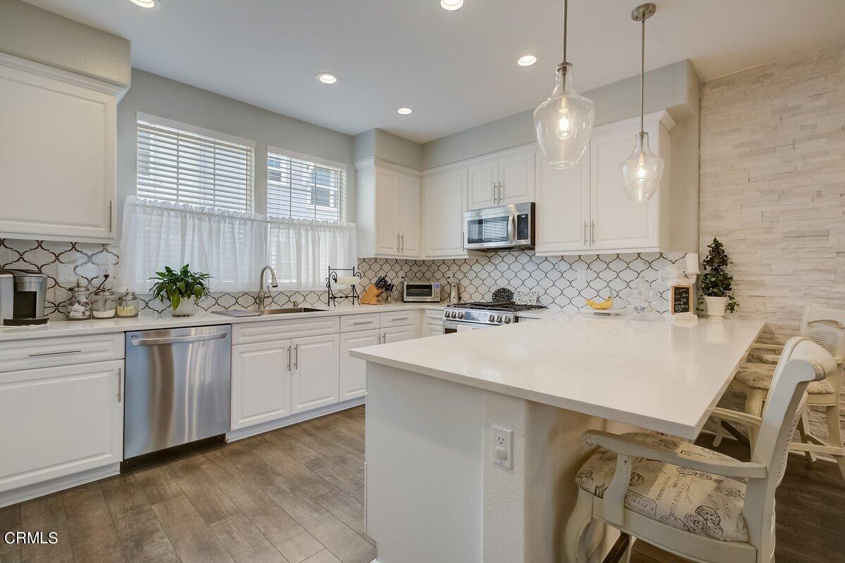 3654 Islander Walk Oxnard, CA 93035 - Photo 18 of 61 a kitchen with a sink a window and cabinets