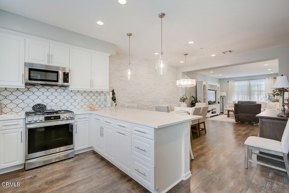 3654 Islander Walk Oxnard, CA 93035 - Photo 21 of 61 a kitchen with a sink stove and microwave
