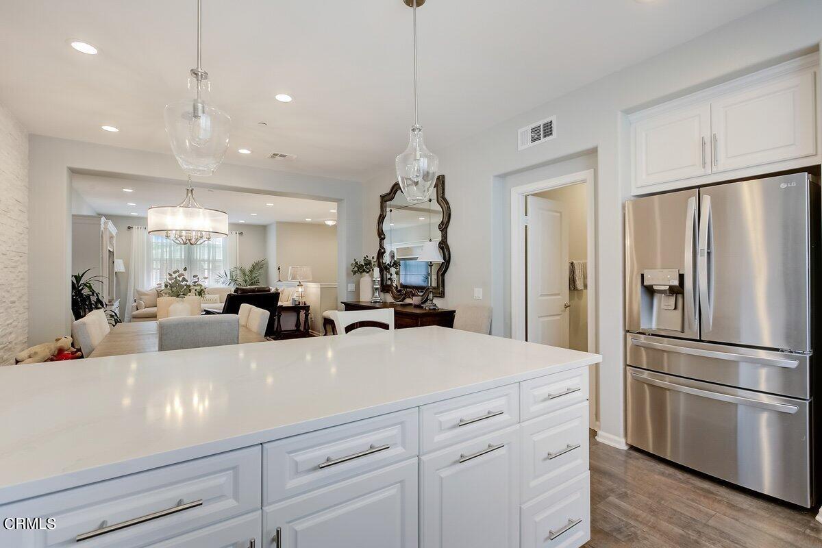 3654 Islander Walk Oxnard, CA 93035 - Photo 24 of 61 a kitchen with kitchen island a counter top space stainless steel appliances and cabinets