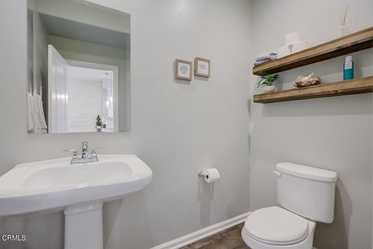 3654 Islander Walk Oxnard, CA 93035 - Photo 26 of 61 a bathroom with a sink a toilet and mirror