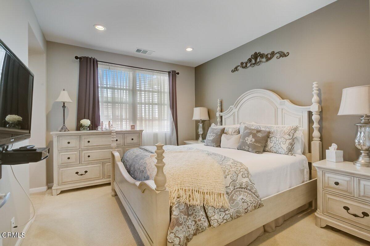 3654 Islander Walk Oxnard, CA 93035 - Photo 27 of 61 a bedroom with a large bed and flat tv screen