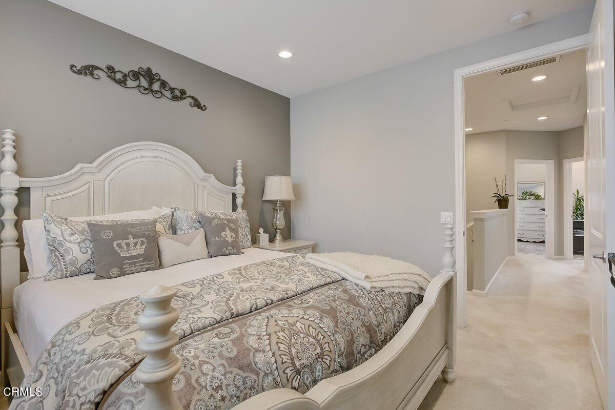 3654 Islander Walk Oxnard, CA 93035 - Photo 28 of 61 a bedroom with a large bed and chandelier