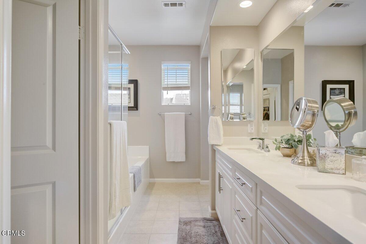 3654 Islander Walk Oxnard, CA 93035 - Photo 33 of 61 a spacious bathroom with a double vanity sink a mirror and a bathtub