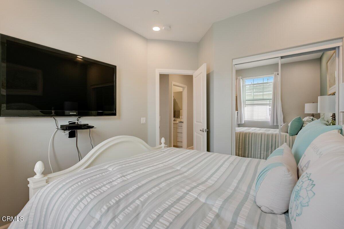 3654 Islander Walk Oxnard, CA 93035 - Photo 37 of 61 a bedroom with a bed and a flat tv screen on wall