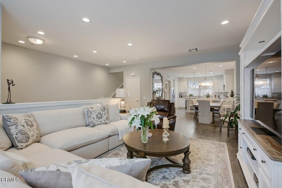 3654 Islander Walk Oxnard, CA 93035 - Photo 9 of 61 a living room with furniture and a dining table with kitchen view
