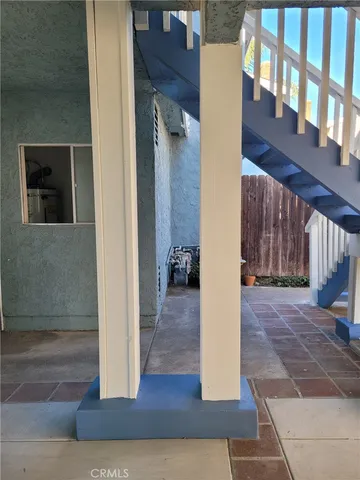 a view of a hallway with wooden floor and a living room