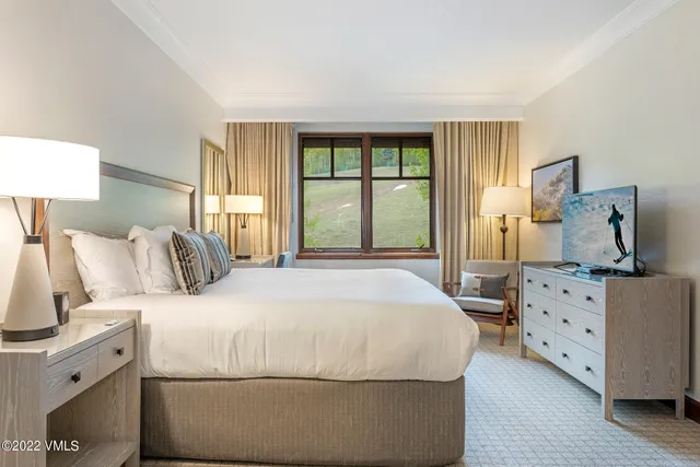 a bedroom with a large bed and a dresser