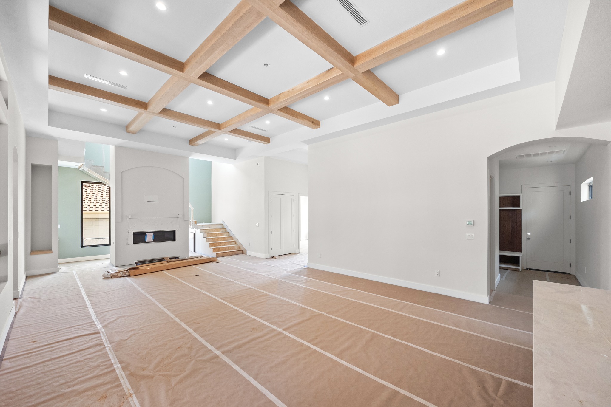 903 Flint Ridge Trail Georgetown, TX 78628 - Photo 7 of 39 Spacious interior featuring a coffered ceiling with recessed lighting, a built-in fireplace, a large window, a staircase, and an arched entryway