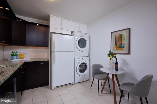 a kitchen with a refrigerator and a stove top oven