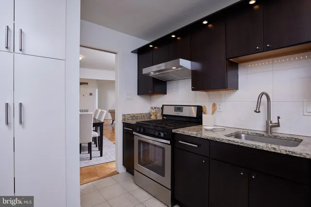 a kitchen with stainless steel appliances a sink and a stove