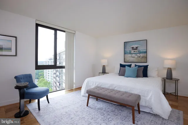 a bedroom with a bed and a window