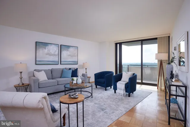 a living room with furniture and floor to ceiling window