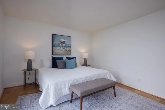 a bedroom with a bed and a lamp on table