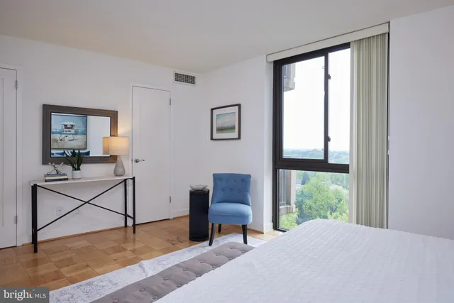 a bedroom with furniture and a window