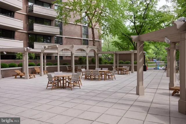 a view of a patio with table and chairs and potted plants