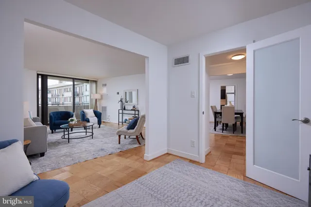 a living room with furniture and a dining table