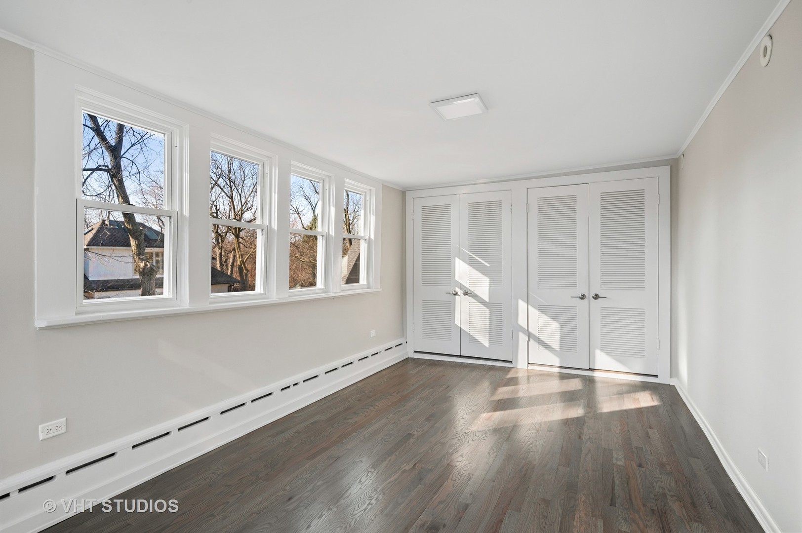 632 Abbotsford Road Kenilworth, IL 60043 - Photo 12 of 30 a view of an empty room with wooden floor and a window
