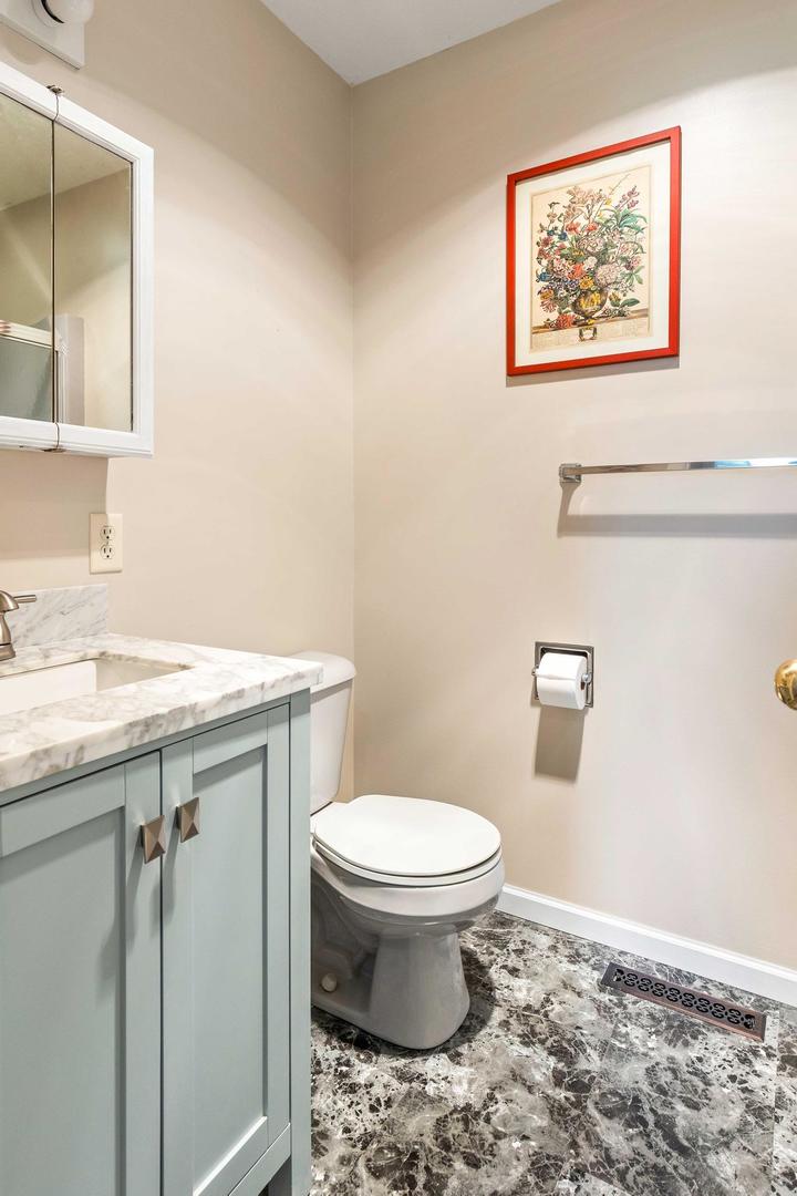 107 Labrador Lane Downs, IL 61736 - Photo 16 of 35 a bathroom with a toilet sink and mirror