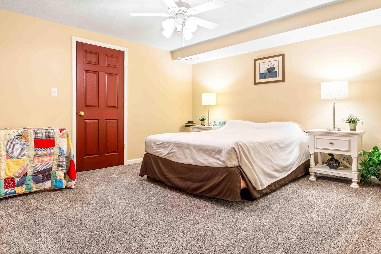 107 Labrador Lane Downs, IL 61736 - Photo 25 of 35 a bedroom with a bed and a chandelier