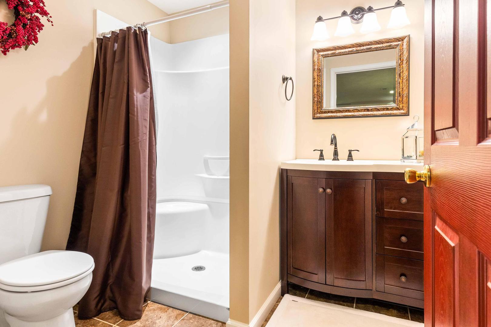 107 Labrador Lane Downs, IL 61736 - Photo 26 of 35 a bathroom with a toilet sink vanity and mirror