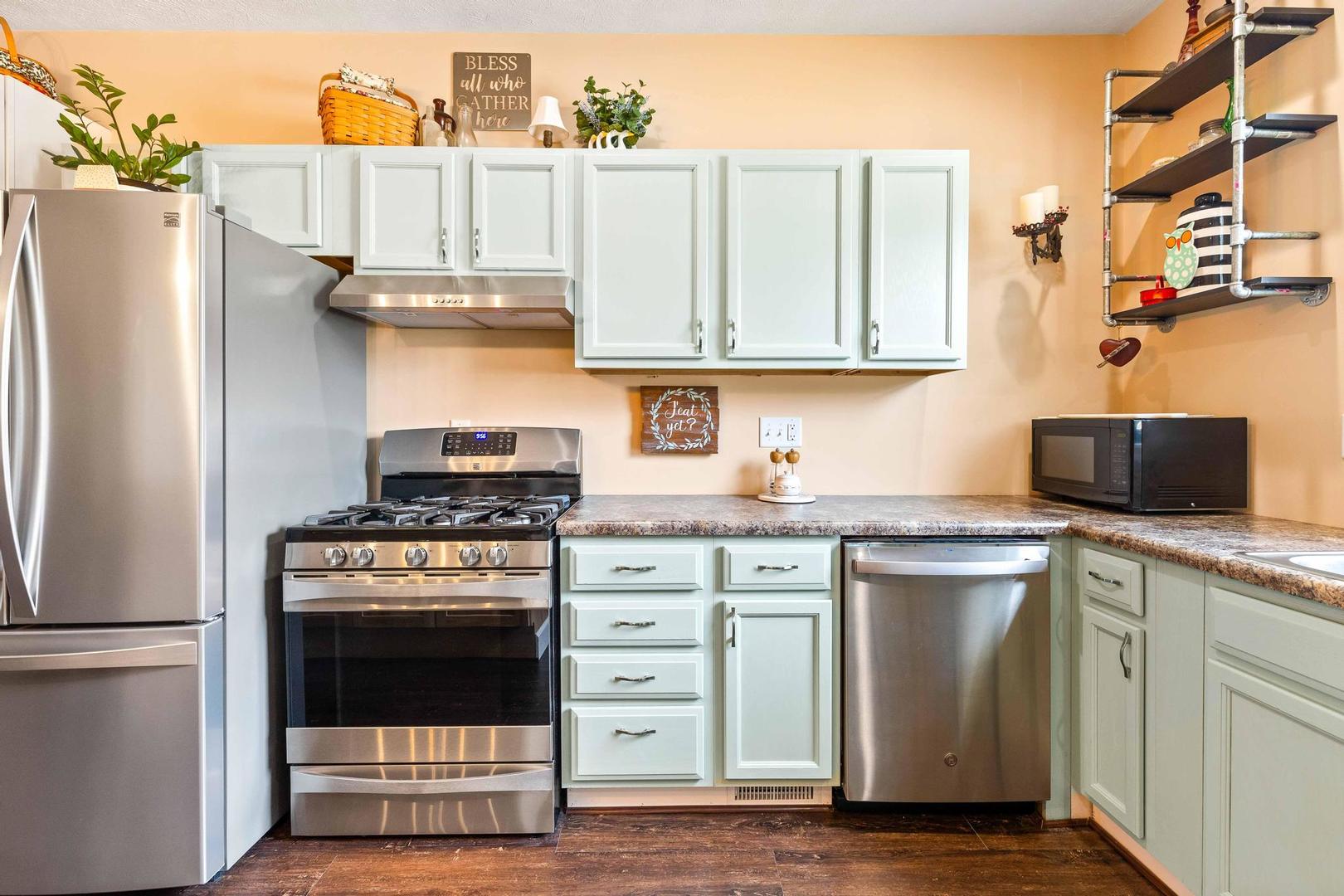 107 Labrador Lane Downs, IL 61736 - Photo 5 of 35 a kitchen with stainless steel appliances granite countertop a stove a refrigerator and a stove