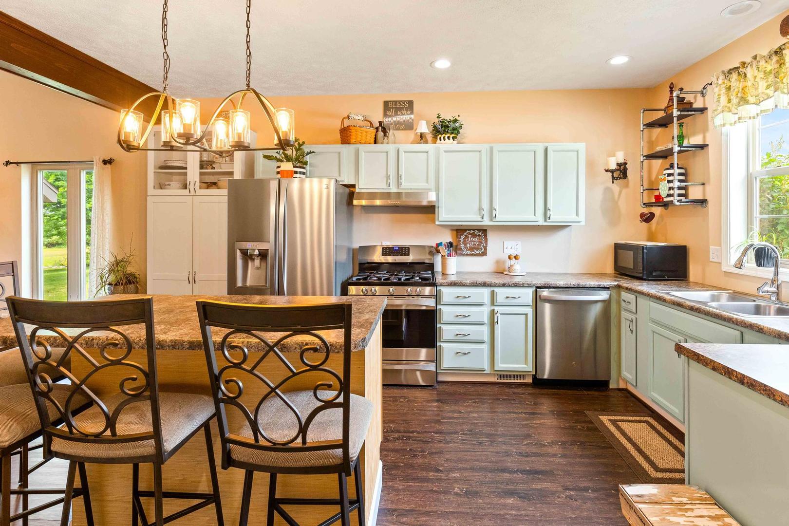 107 Labrador Lane Downs, IL 61736 - Photo 8 of 35 a kitchen that has a lot of white cabinets a sink and appliances