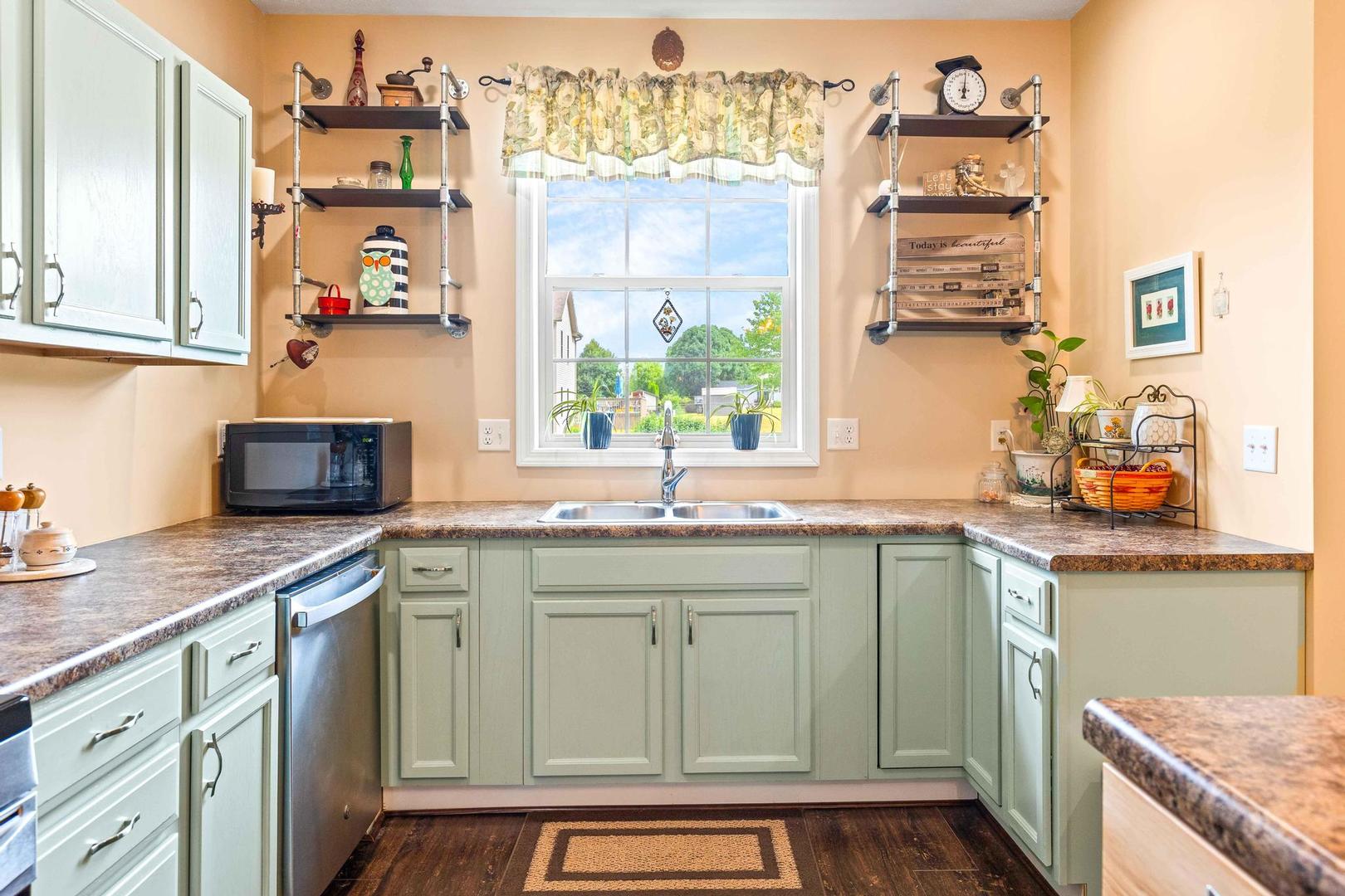 107 Labrador Lane Downs, IL 61736 - Photo 9 of 35 a kitchen with stainless steel appliances granite countertop a sink stove and cabinets