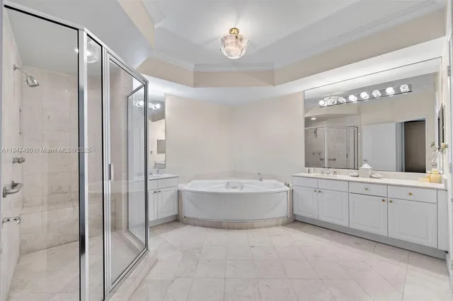 a bathroom with a tub sink shower and mirror