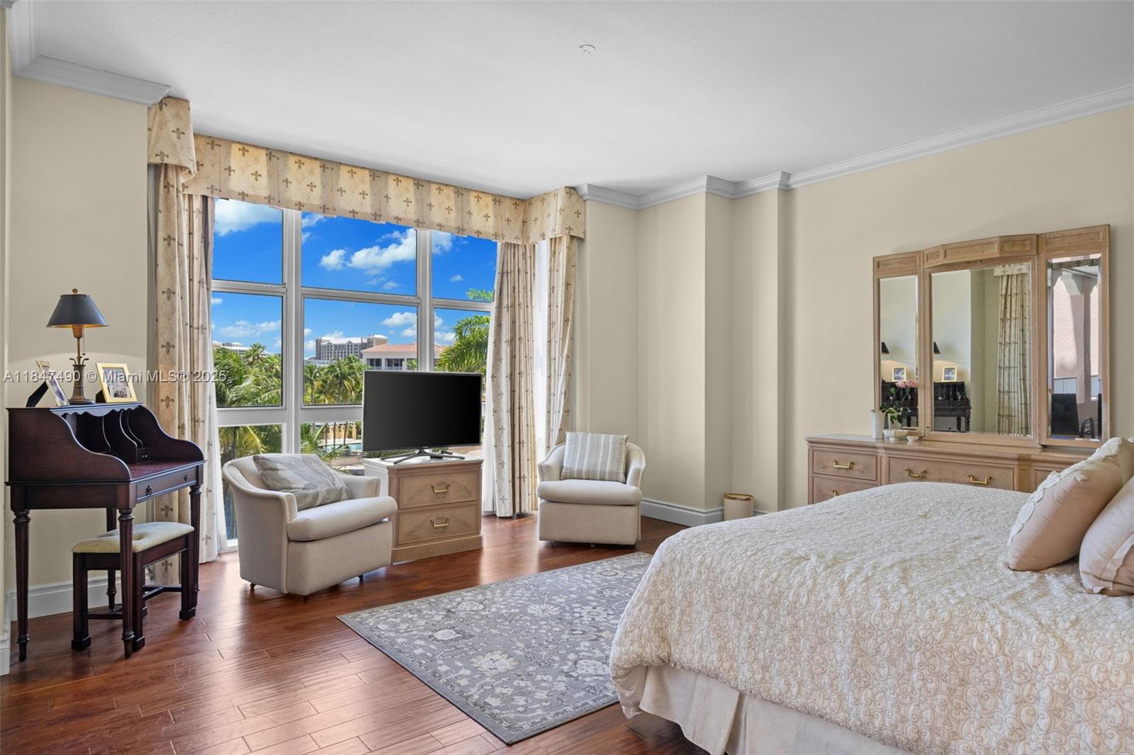 733 Crandon Boulevard, Unit 405 Key Biscayne, FL 33149 - Photo 18 of 42 a bedroom with a bed and large window