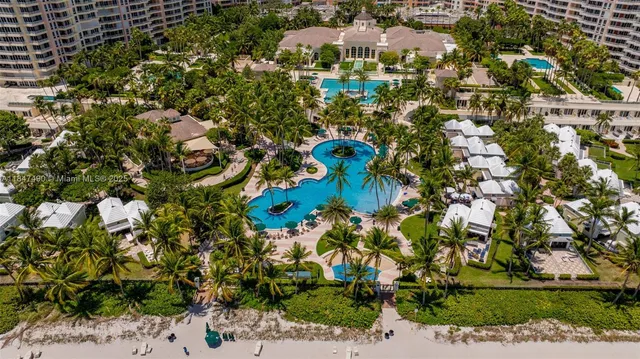 an aerial view of multiple houses with yard
